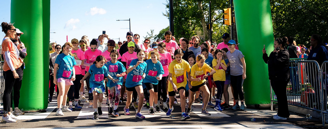 Image of young girls at the start line of a 5k event.