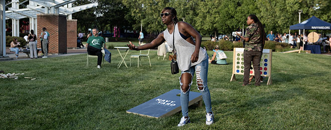 Image of woman playing cornhole.